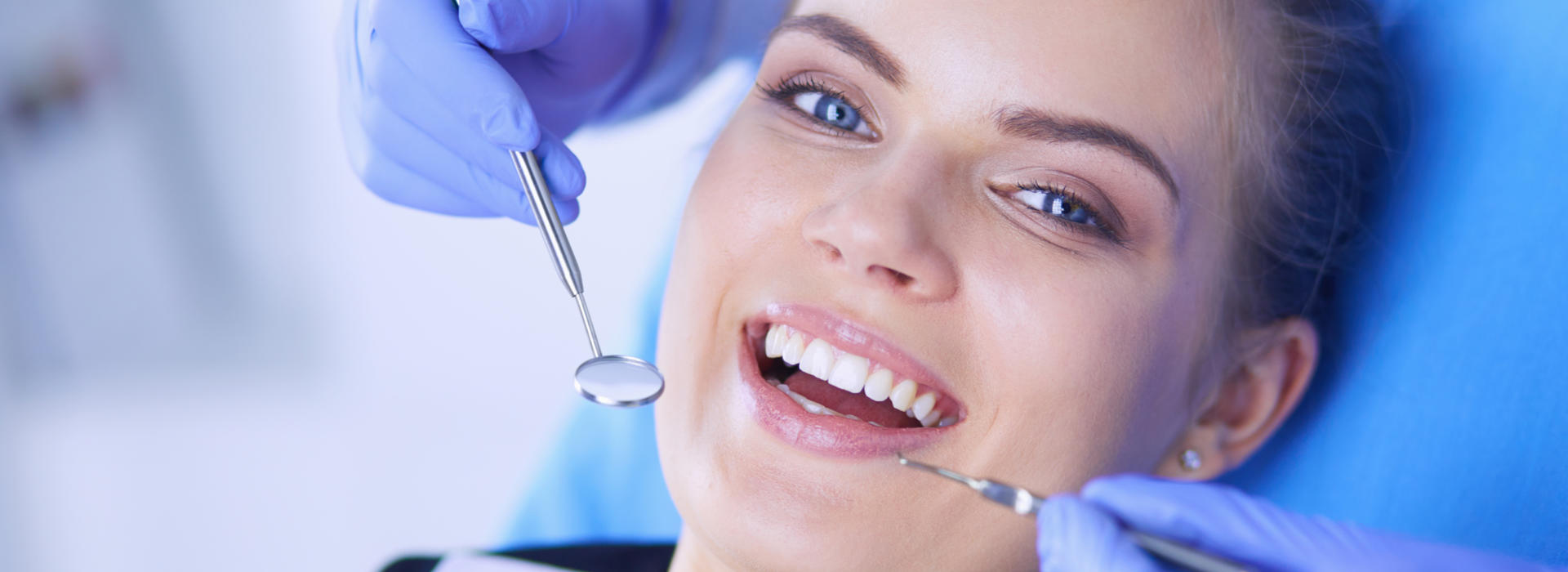 A woman is smiling after dental sealant.